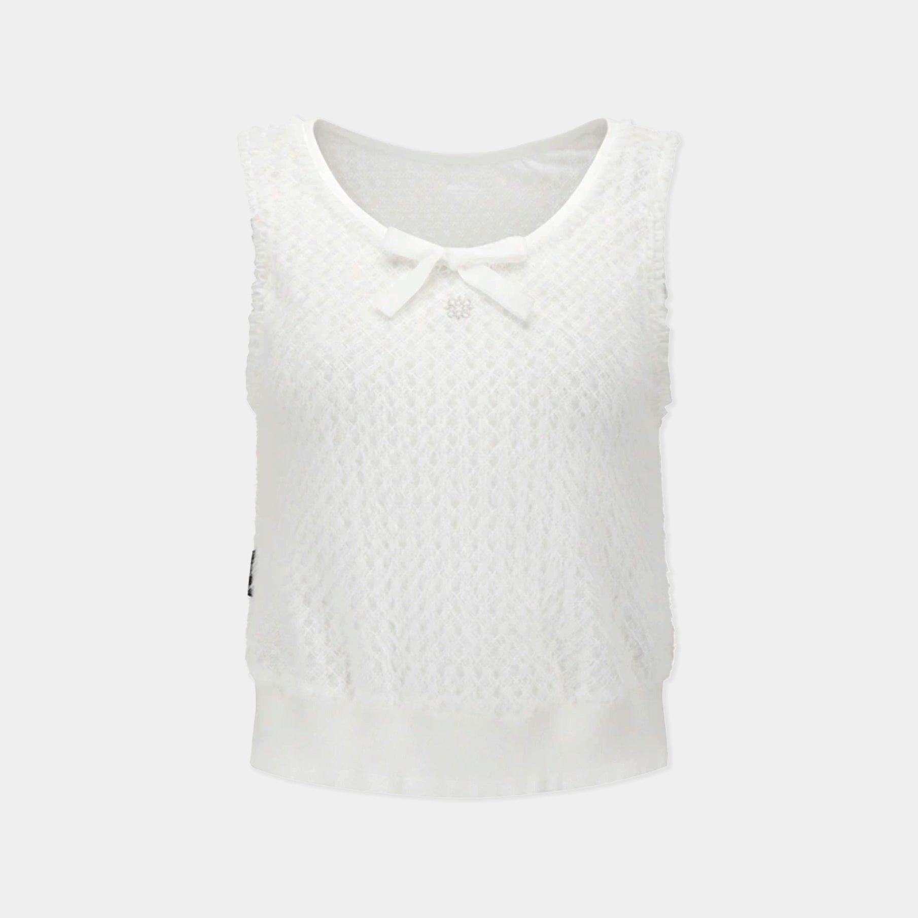 A sleeveless white knit top with a textured pattern, a scoop neckline, a small bow detail at the center, and a ruffled hem, shown against a light gray background.