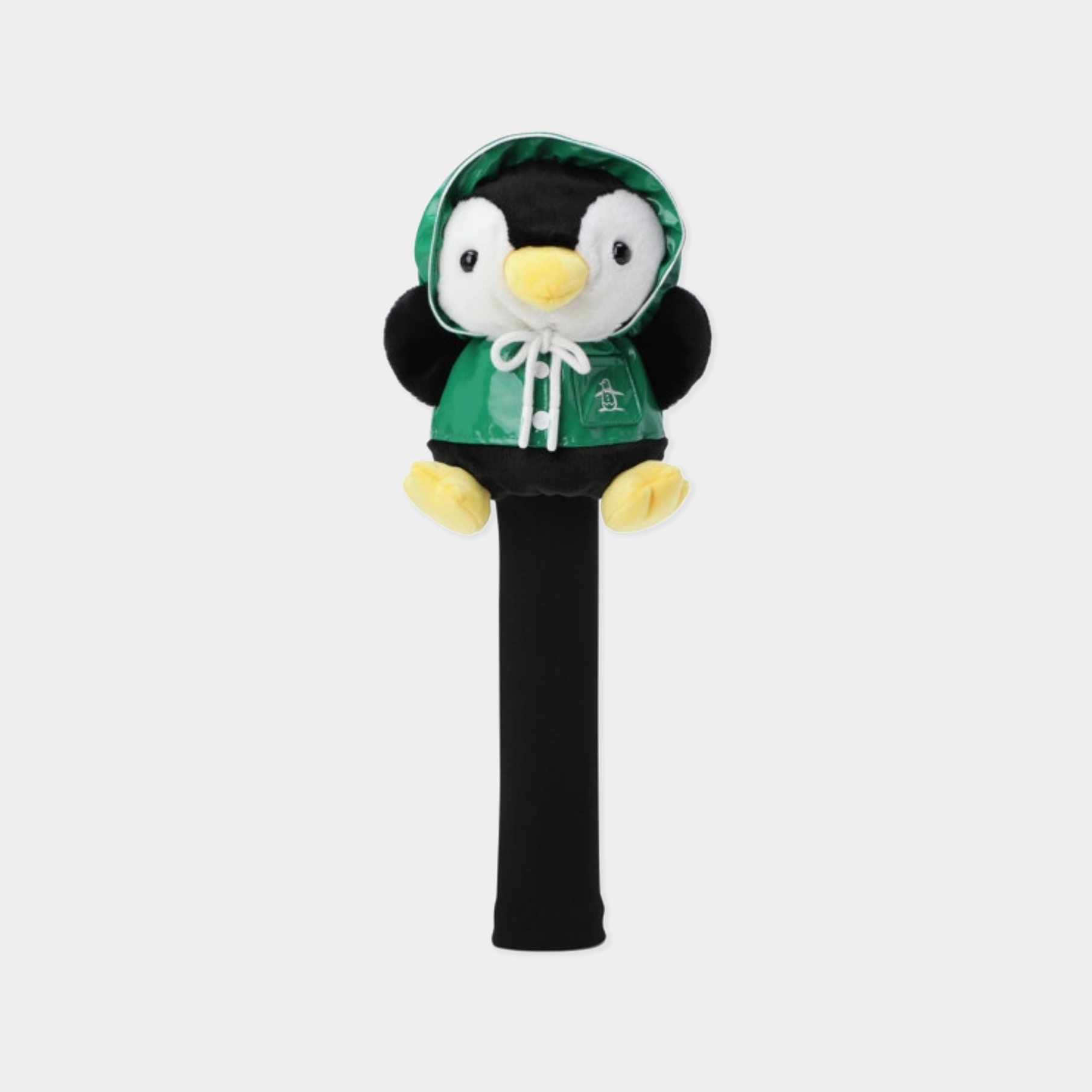 A plush penguin character head on a black cylindrical handle, wearing a green hooded sweatshirt with a white drawstring and yellow feet, shown against a light gray background.