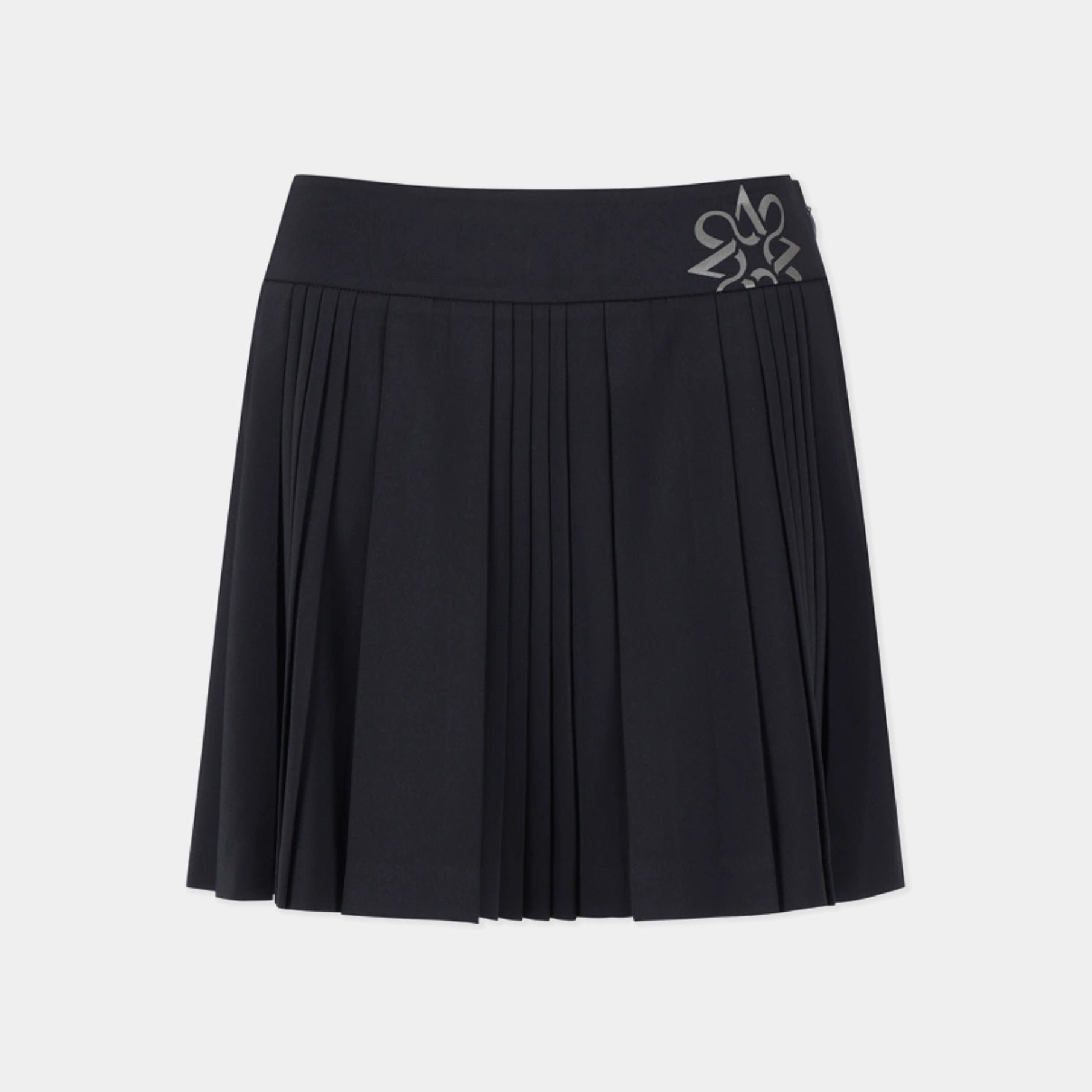 A black pleated athletic skirt with a wide waistband and a silver embroidered logo on the right side, shown against a light gray background.