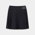 A black pleated athletic skirt with a wide waistband and a silver embroidered logo on the right side, shown against a light gray background.