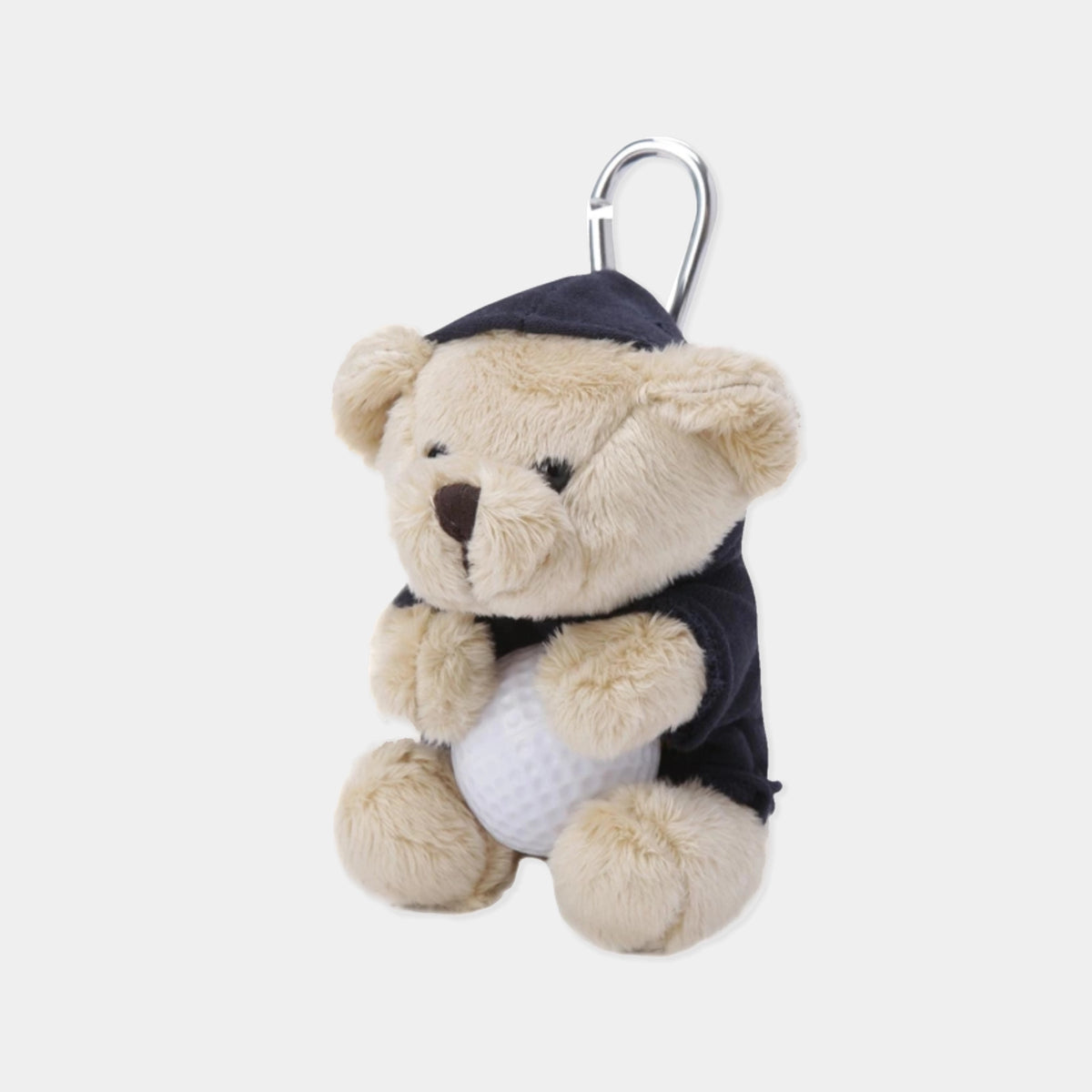 A plush teddy bear keychain or bag charm with a silver carabiner. The bear is beige with a dark navy blue hat and sweater, holding a white golf ball.