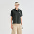 A model wearing a dark olive green short-sleeve polo shirt with a small white embroidered logo on the left chest, paired with beige pants, a beige visor, and a white golf glove, against a light gray studio background.