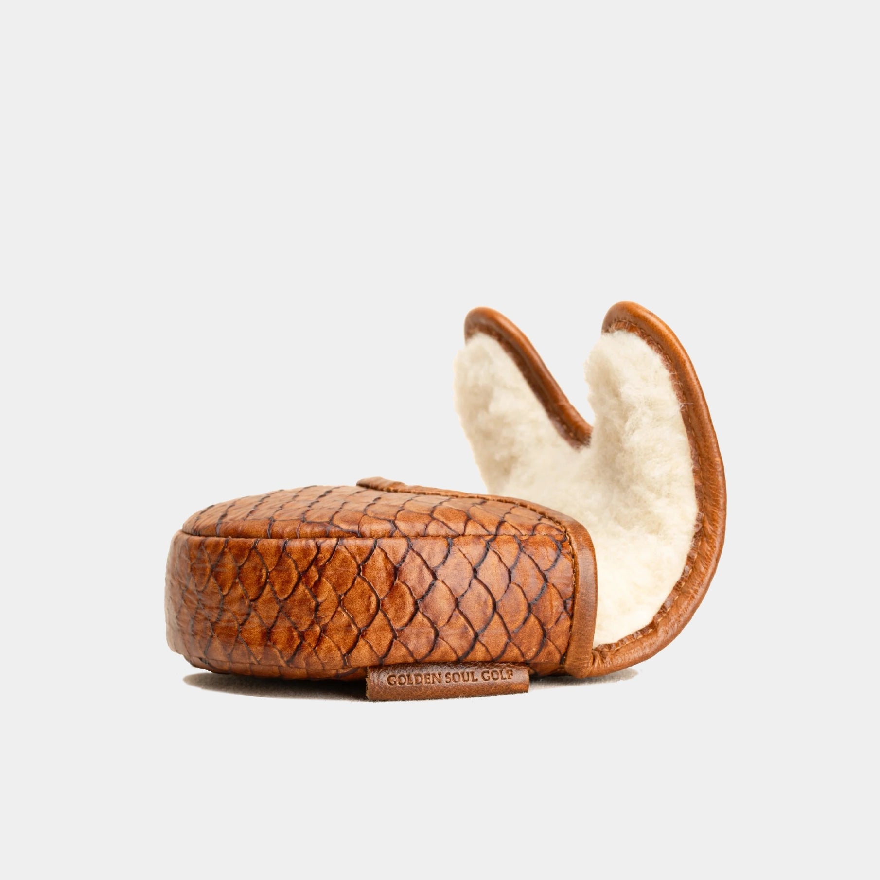 A small brown crocodile-embossed leather OZ1 Putter Cover with a cream-colored shearling lining, shown open against a light gray background.