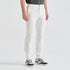 A model from the waist down wearing slim-fit white trousers and dark gray and navy sneakers, standing against a clean white studio background.