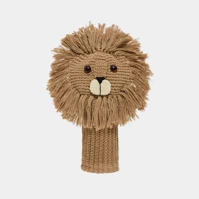 A hand-knitted lion head golf club cover in shades of tan and brown, featuring a textured mane, embroidered facial features, and a knitted neck sleeve, shown against a plain light gray background.