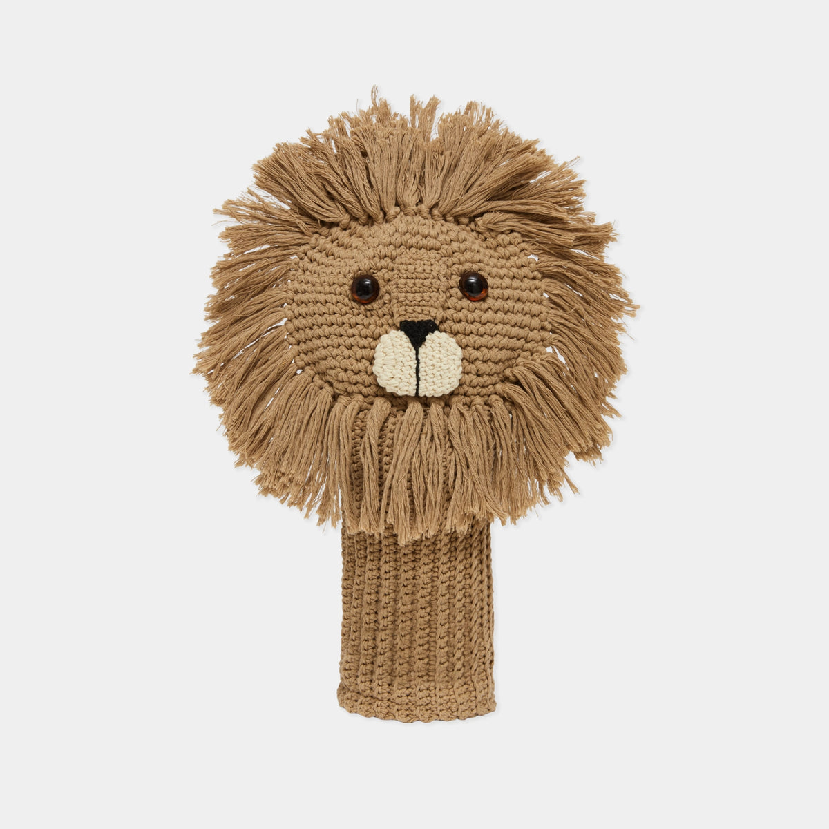A hand-knitted lion head golf club cover in shades of tan and brown, featuring a textured mane, embroidered facial features, and a knitted neck sleeve, shown against a plain light gray background.
