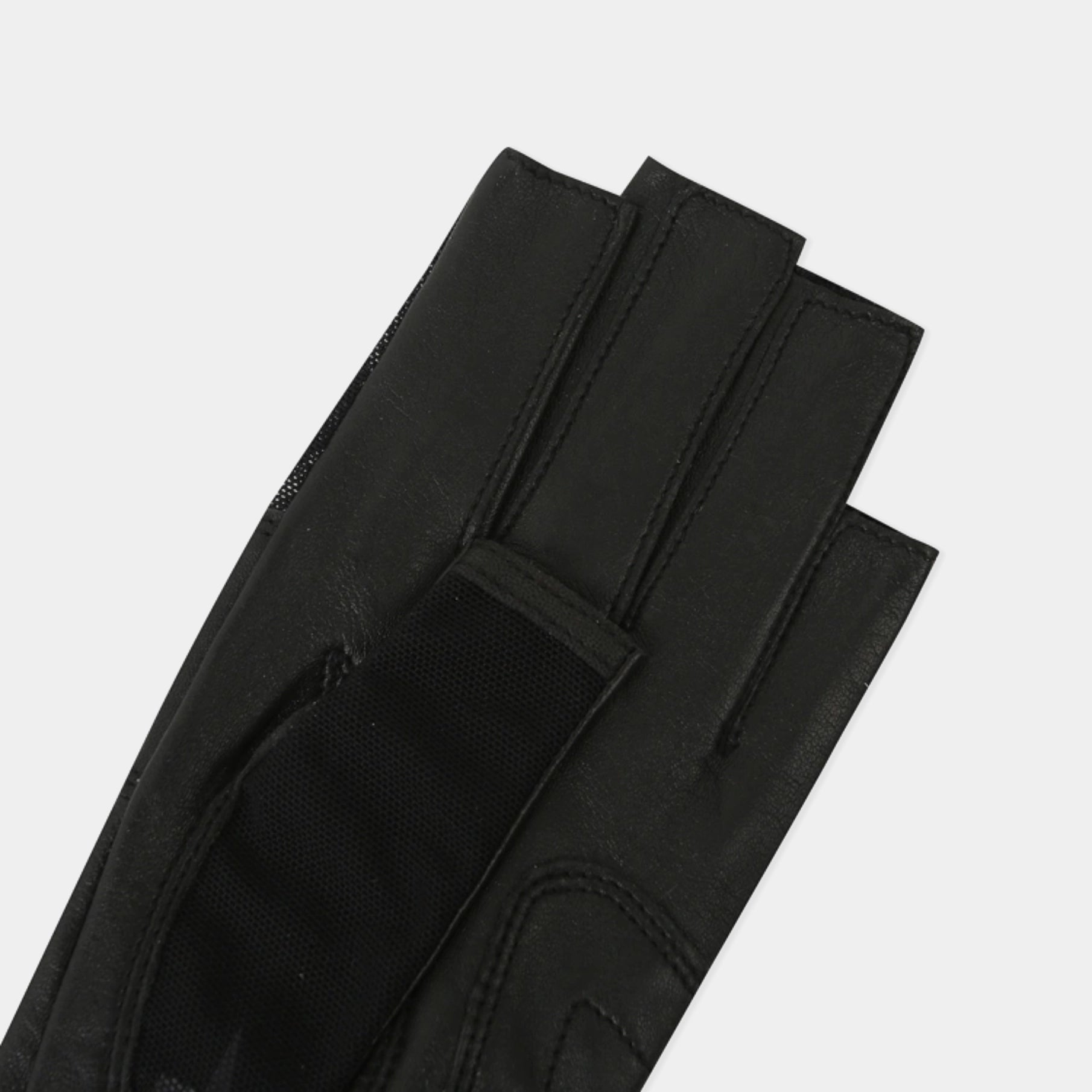 A close-up of a black leather glove with a textured fabric cuff and hook-and-loop strap closure, shown on a light gray background.
