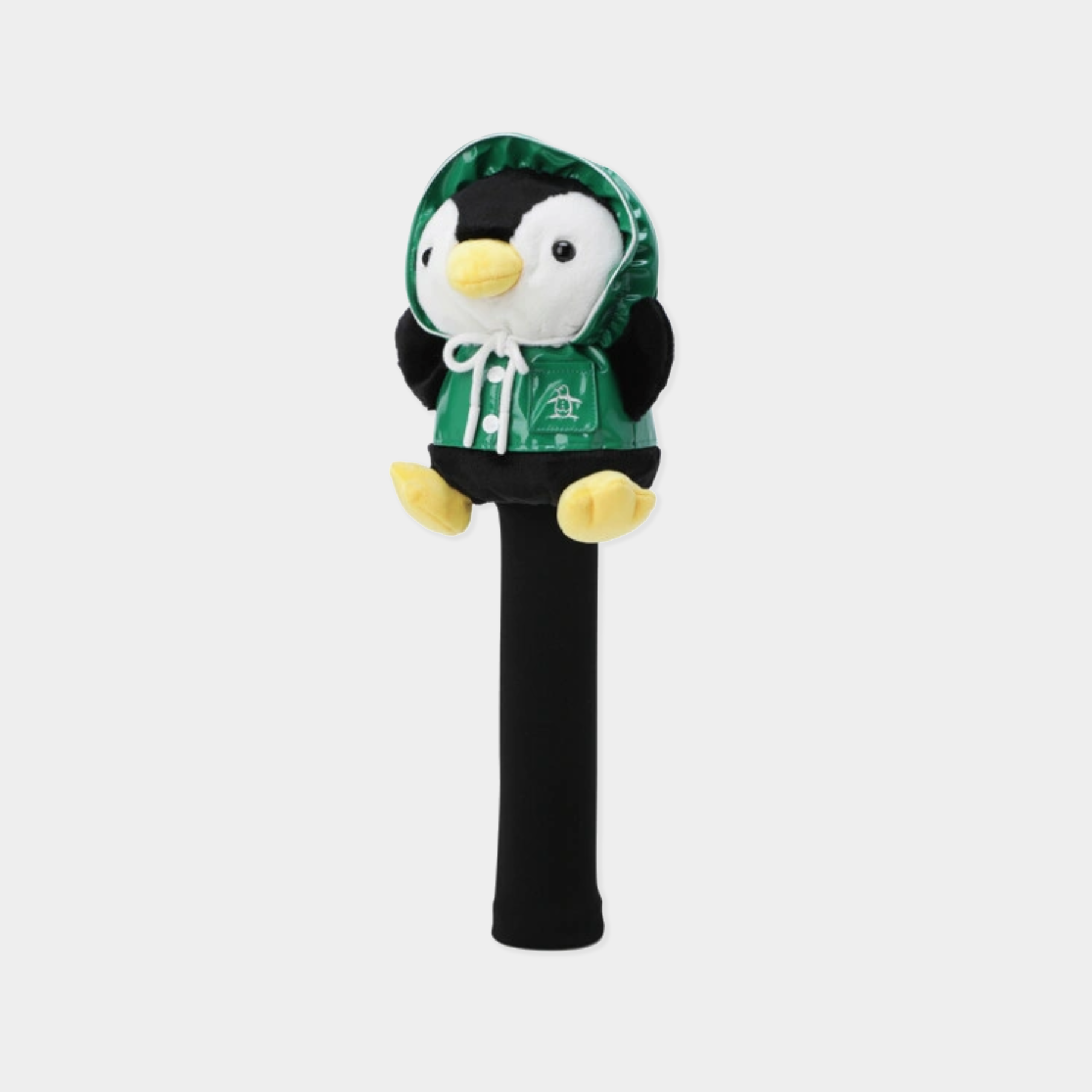 A plush penguin golf club headcover featuring a hooded penguin character wearing a green hoodie with a white drawstring and a small white logo, mounted on a black cylindrical cover, set against a light gray background.