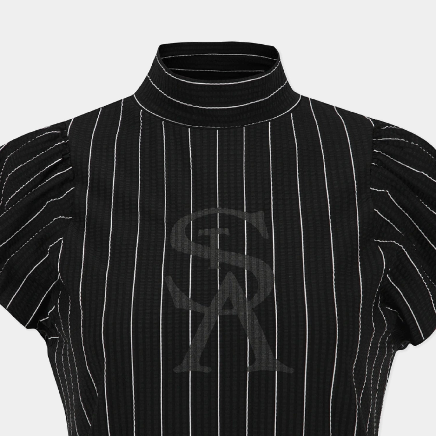 A close-up of a black short-sleeve mock neck top with thin white vertical pinstripes and a tonal dark gray interlocking 'SA' logo on the chest, set against a light gray background.