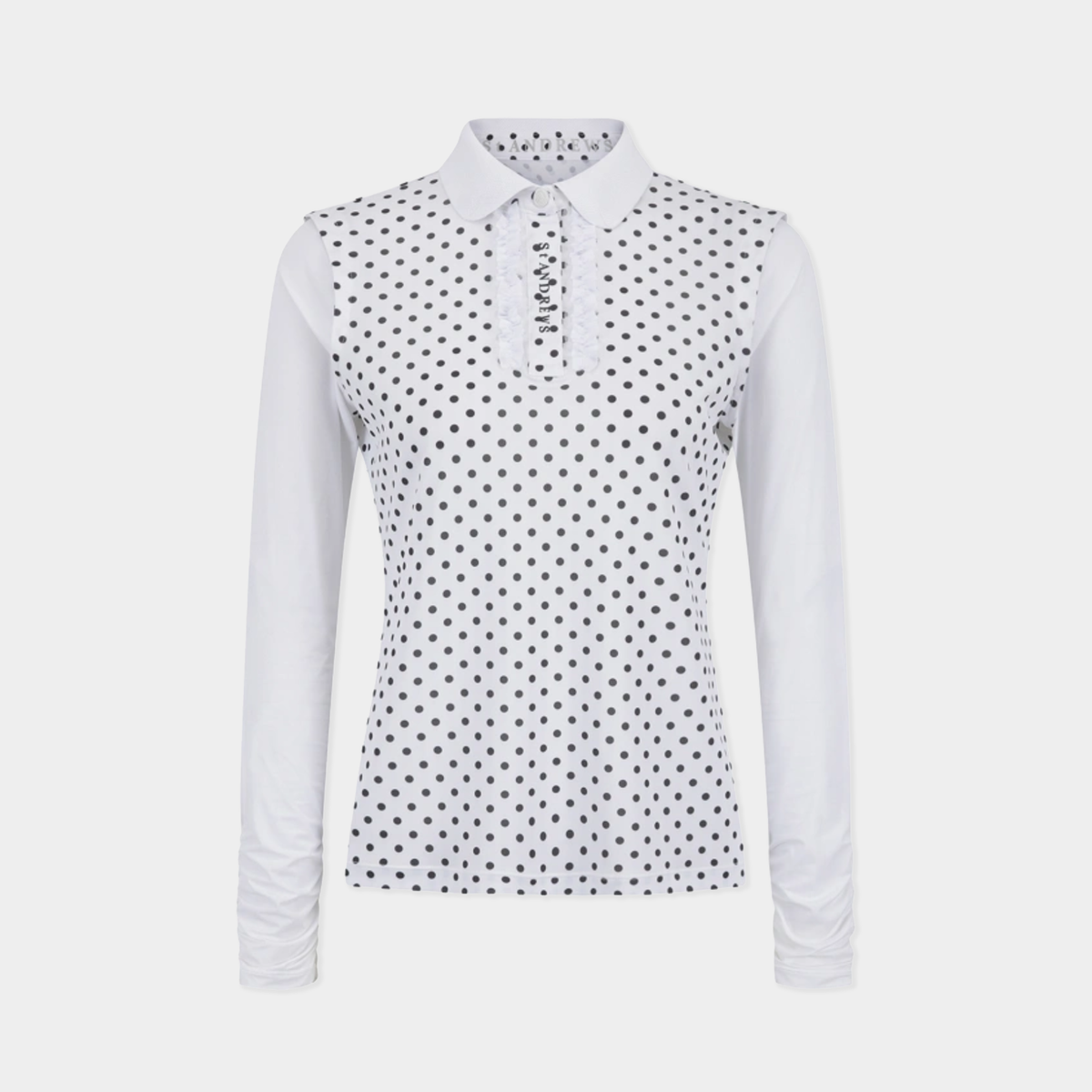 A women's long-sleeve polo shirt in white with a black polka dot pattern across the body and collar, shown on a light gray background.