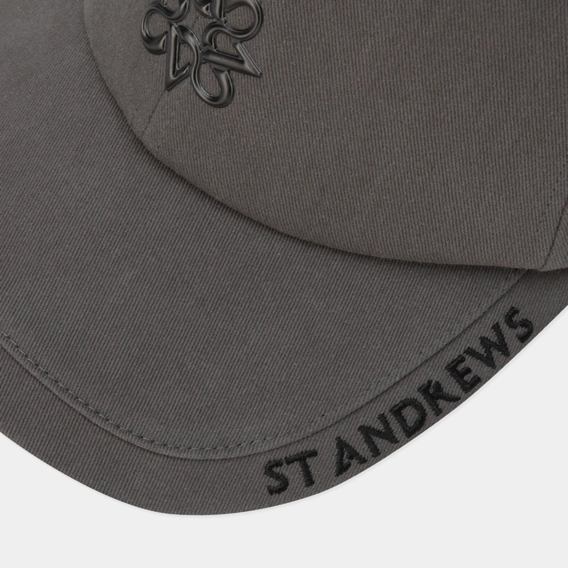 Close-up of a dark gray St Andrews baseball cap showing the embroidered St Andrews cross logo on the front and 'ST ANDREWS' text on the brim.