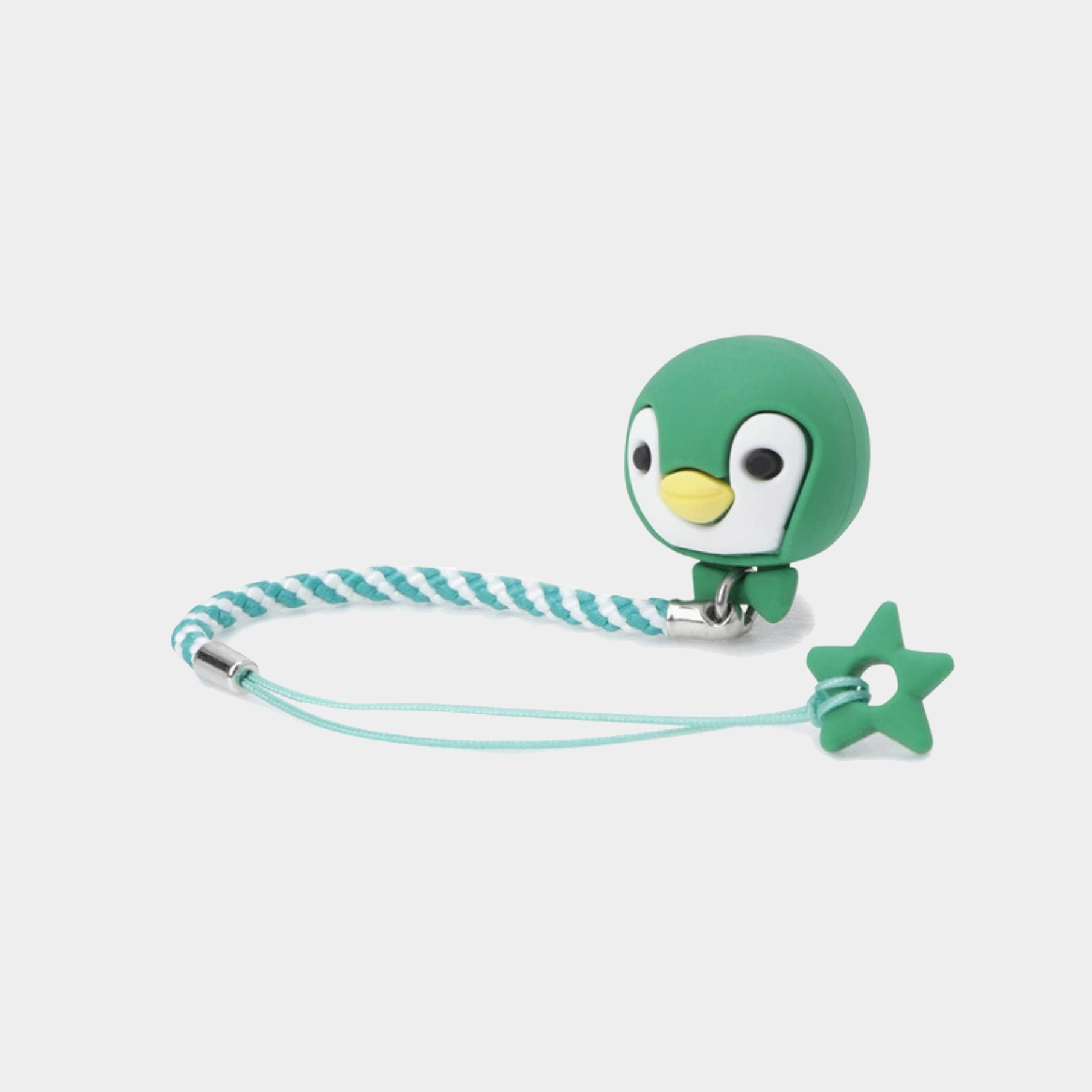 A green penguin-shaped clip with a braided mint and teal strap and a small star-shaped charm, shown on a light gray background.