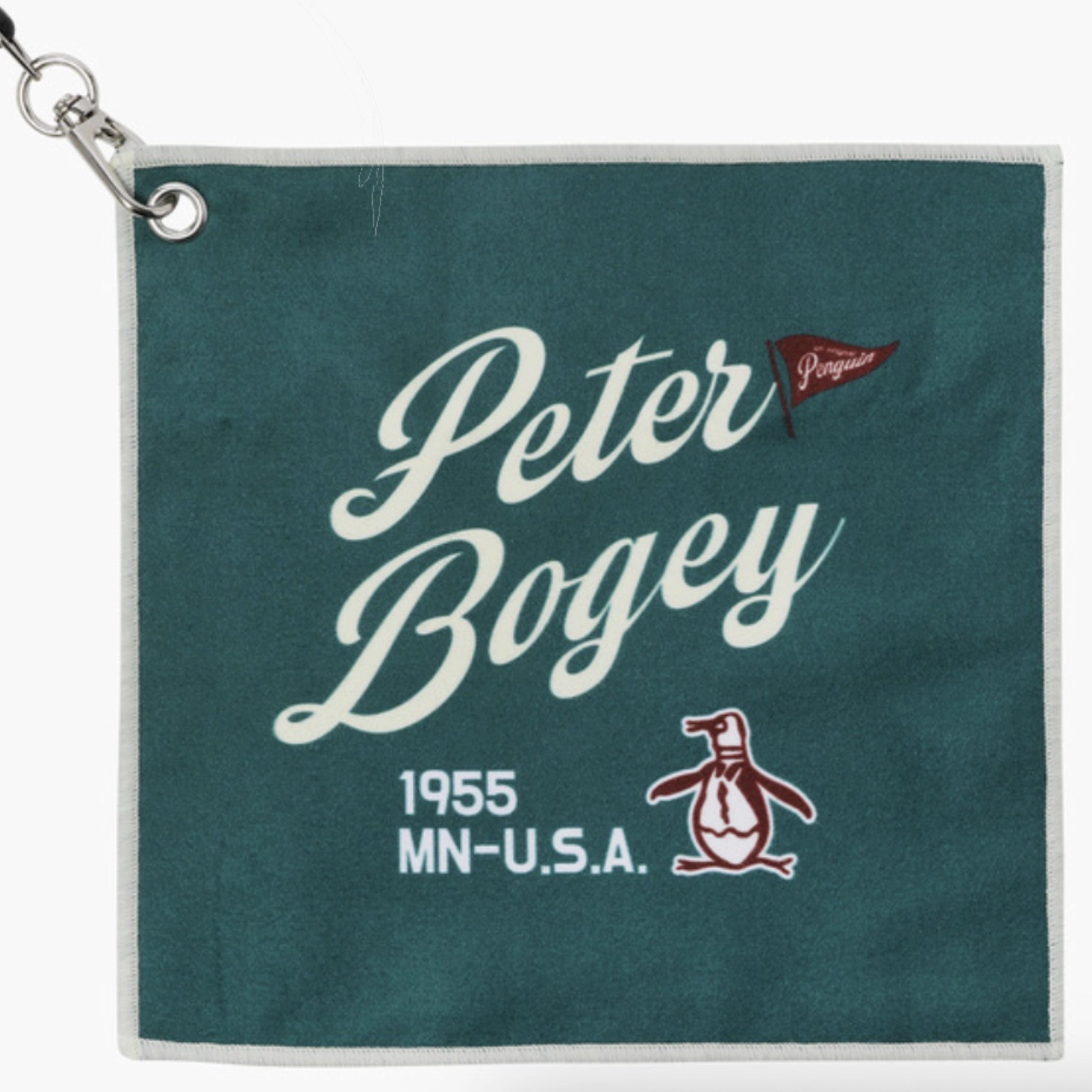 A square dark teal golf towel with a silver metal grommet and clip in the top-left corner. The towel features white script text reading 'Peter Bogey' with a small red flag accent, and '1955 MN-U.