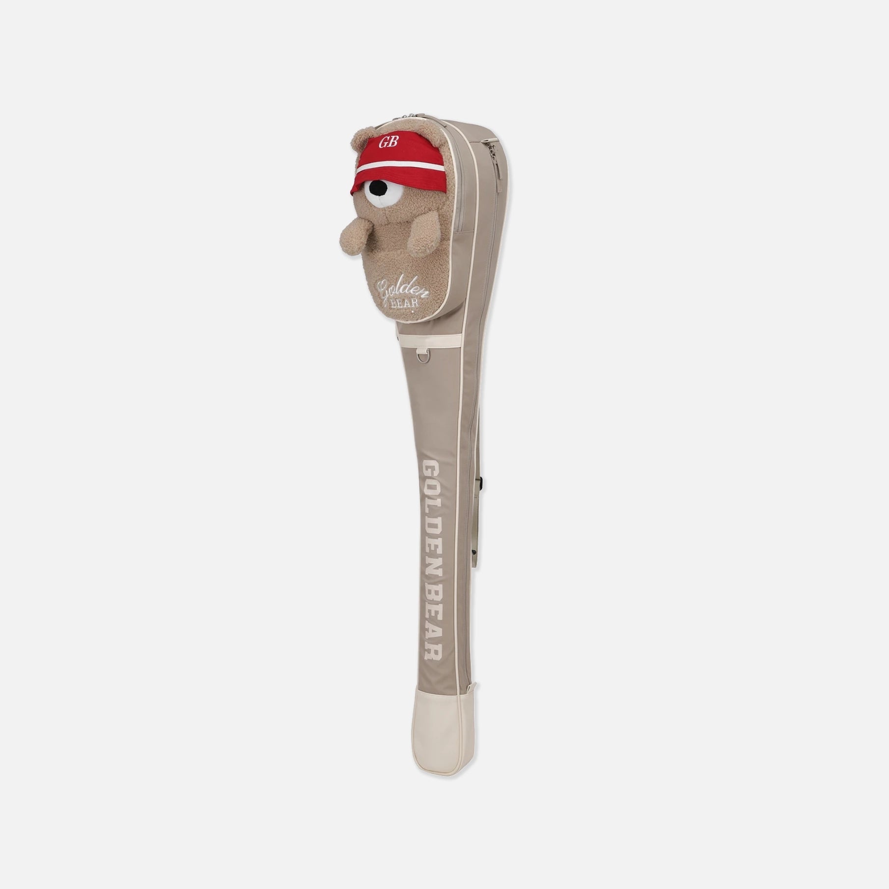 A golf club headcover featuring a plush golden bear wearing a red headband with 'GB' on it, set against a light gray background. The headcover is beige with white text reading 'GOLDEN BEAR' and a white logo near the top.