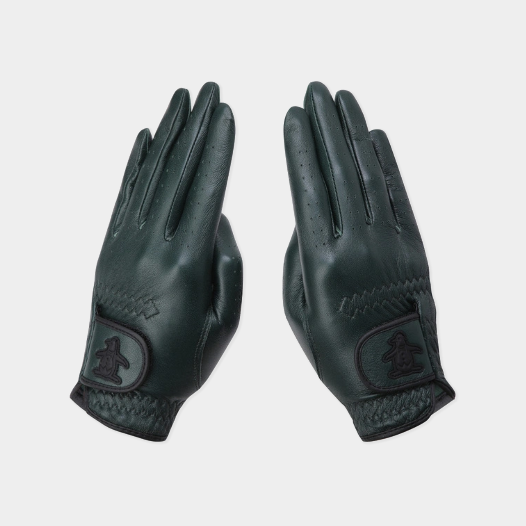 A pair of dark forest green leather golf gloves shown flat against a light gray background, displaying the back of the hands with stitched details and a logo patch on the back of the wrist.