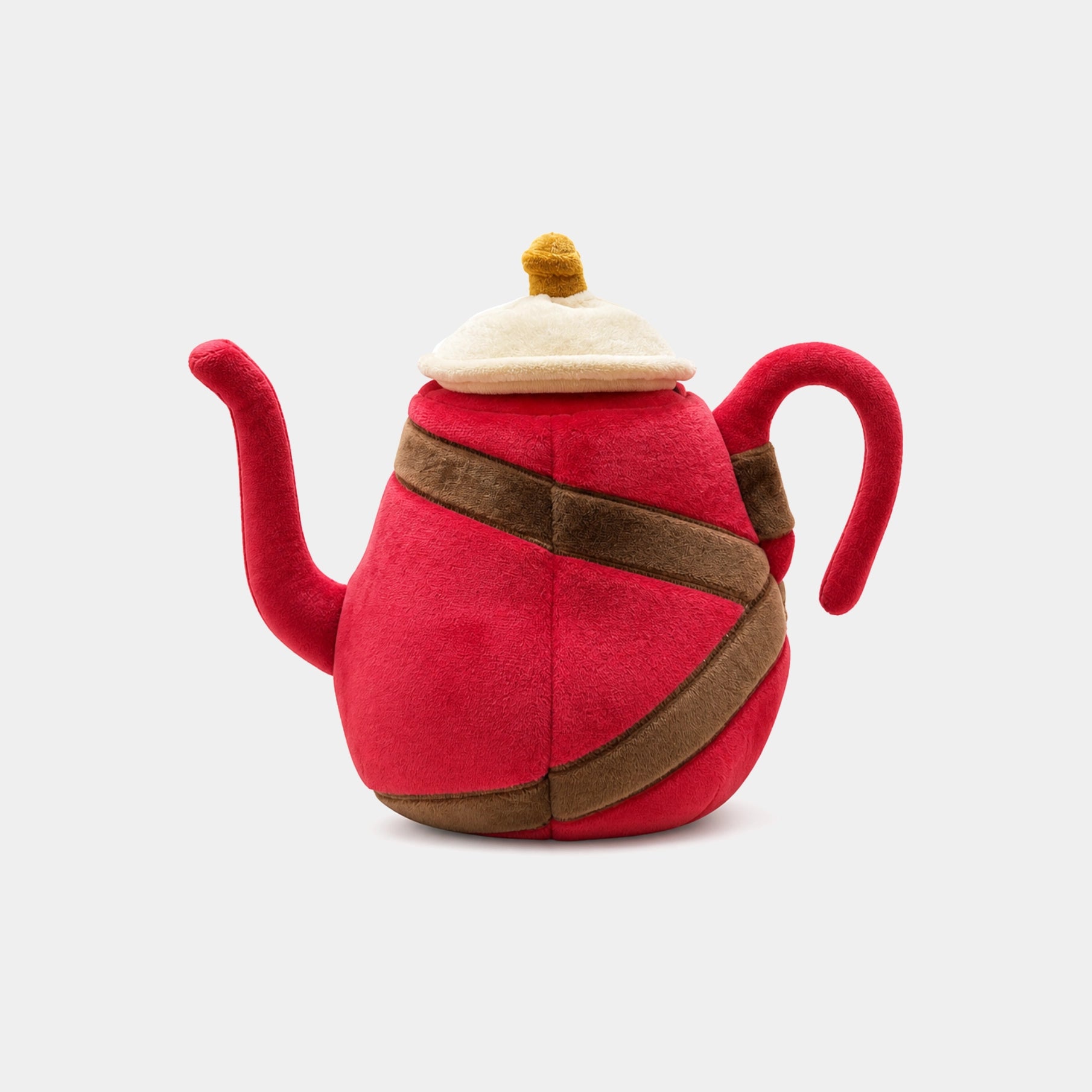 A plush toy teapot hybrid cover, brown wrap-around straps, a cream-colored lid, and a small yellow pom-pom on top, shown against a light gray background.