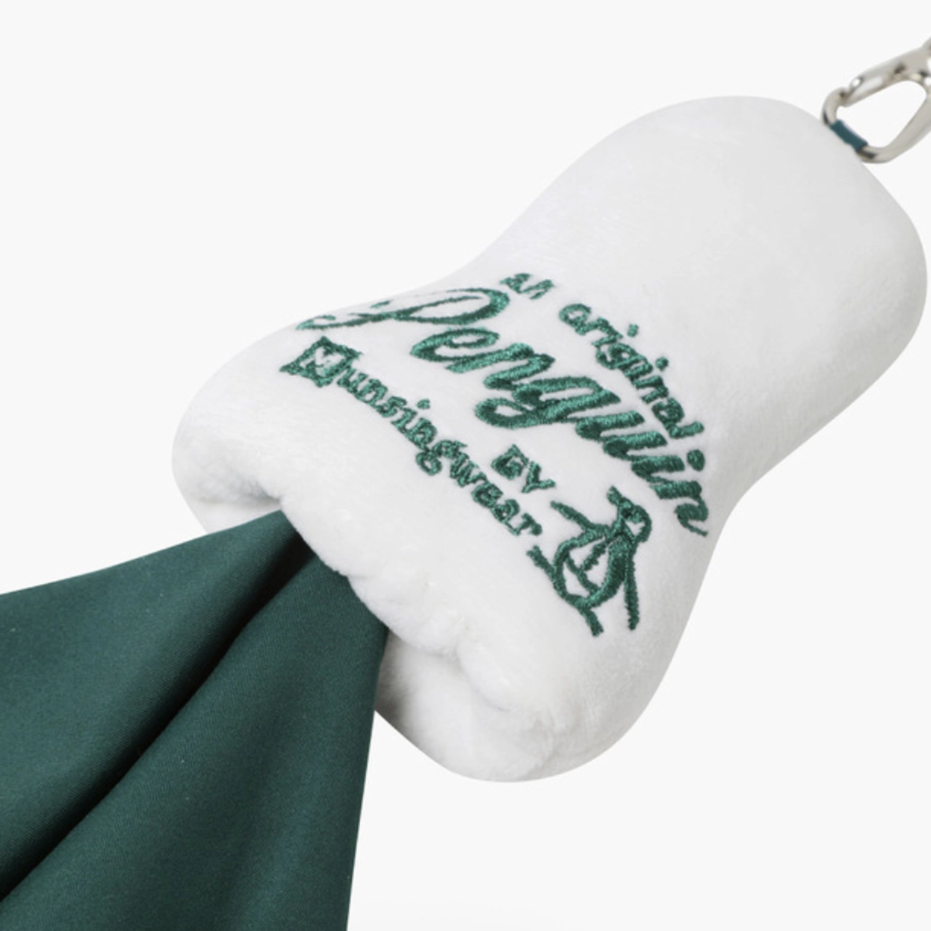White plush golf club headcover with green embroidered text reading 'an original Penguin by Munisgear' and a metal clip attached, shown on a light gray background.