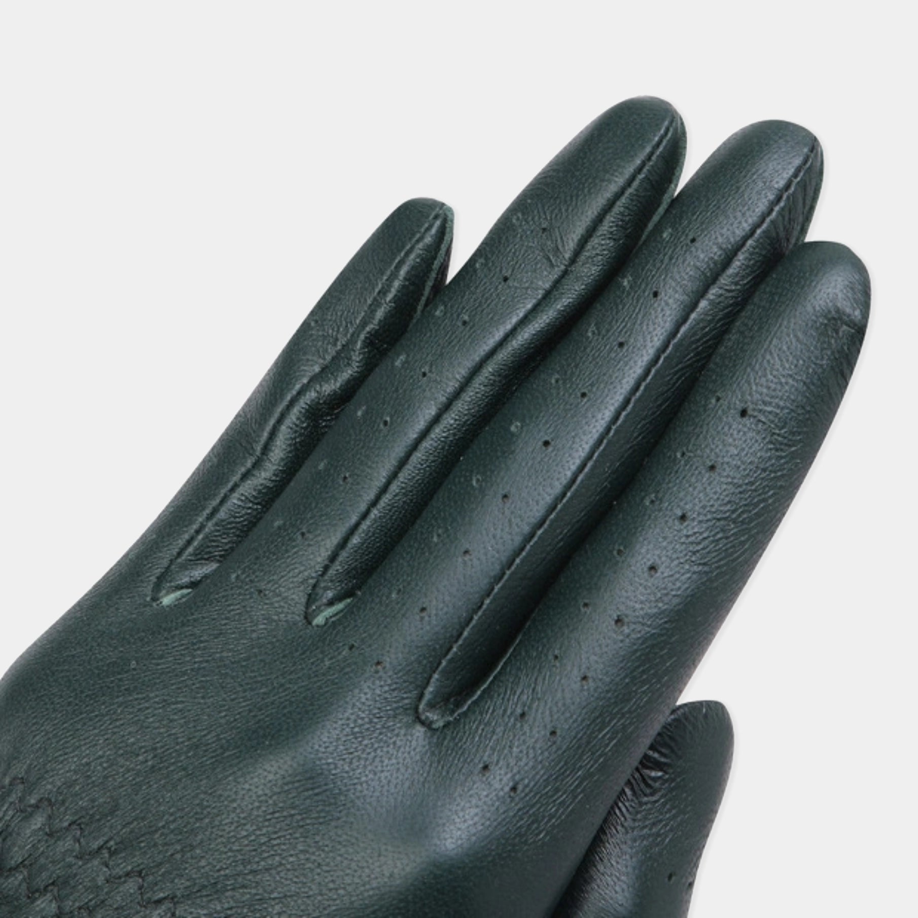 A close-up of a dark green leather glove with perforated details on the fingers, shown against a light gray background.