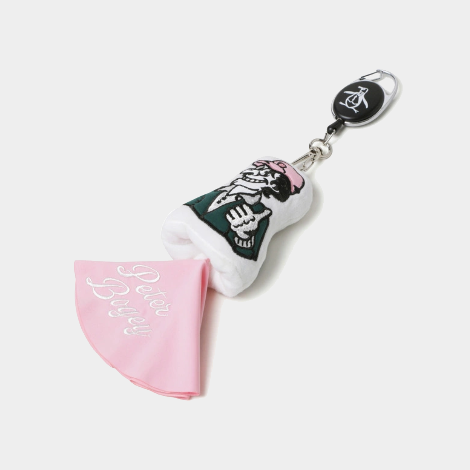 A golf club head cover keychain featuring a white and black illustrated club head with pink accents, attached to a black retractable badge reel, alongside a folded pink microfiber cloth with white cursive text, on a light gray background.