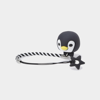 A black and white braided cord bracelet with a 3D penguin charm featuring a yellow beak, and a dangling black star-shaped charm, shown on a light gray background.