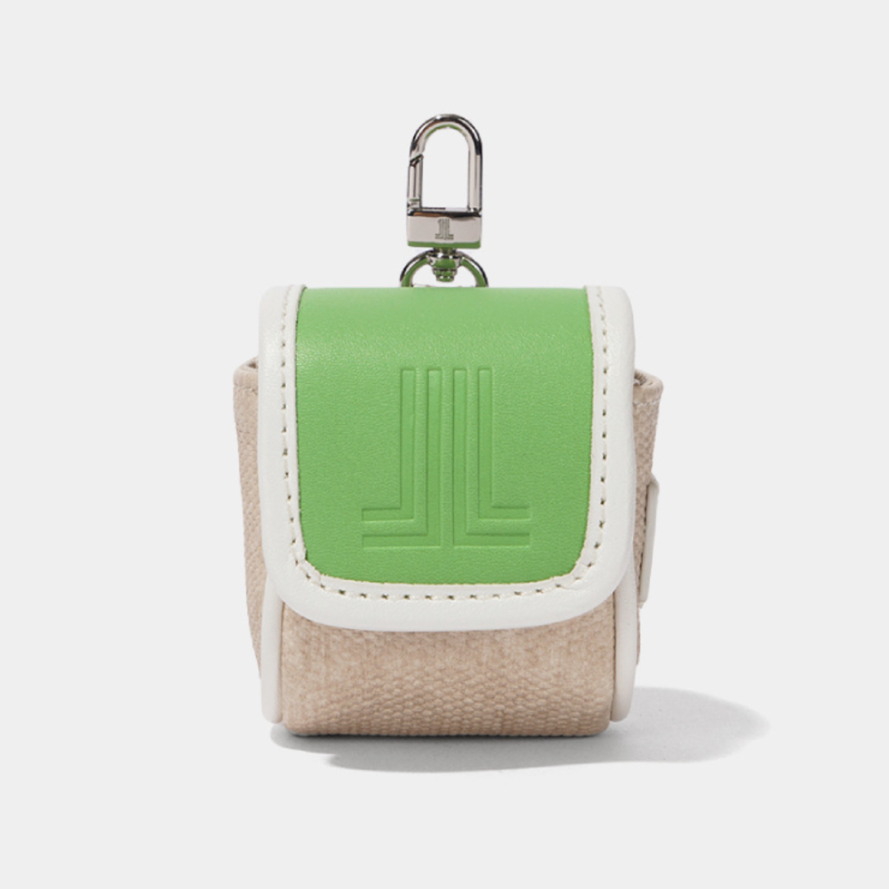 A small Lanvin Blanc key pouch featuring a light green leather front flap with an embossed logo, beige canvas sides, and white contrast stitching, complete with a silver metal key ring on a light gray background.
