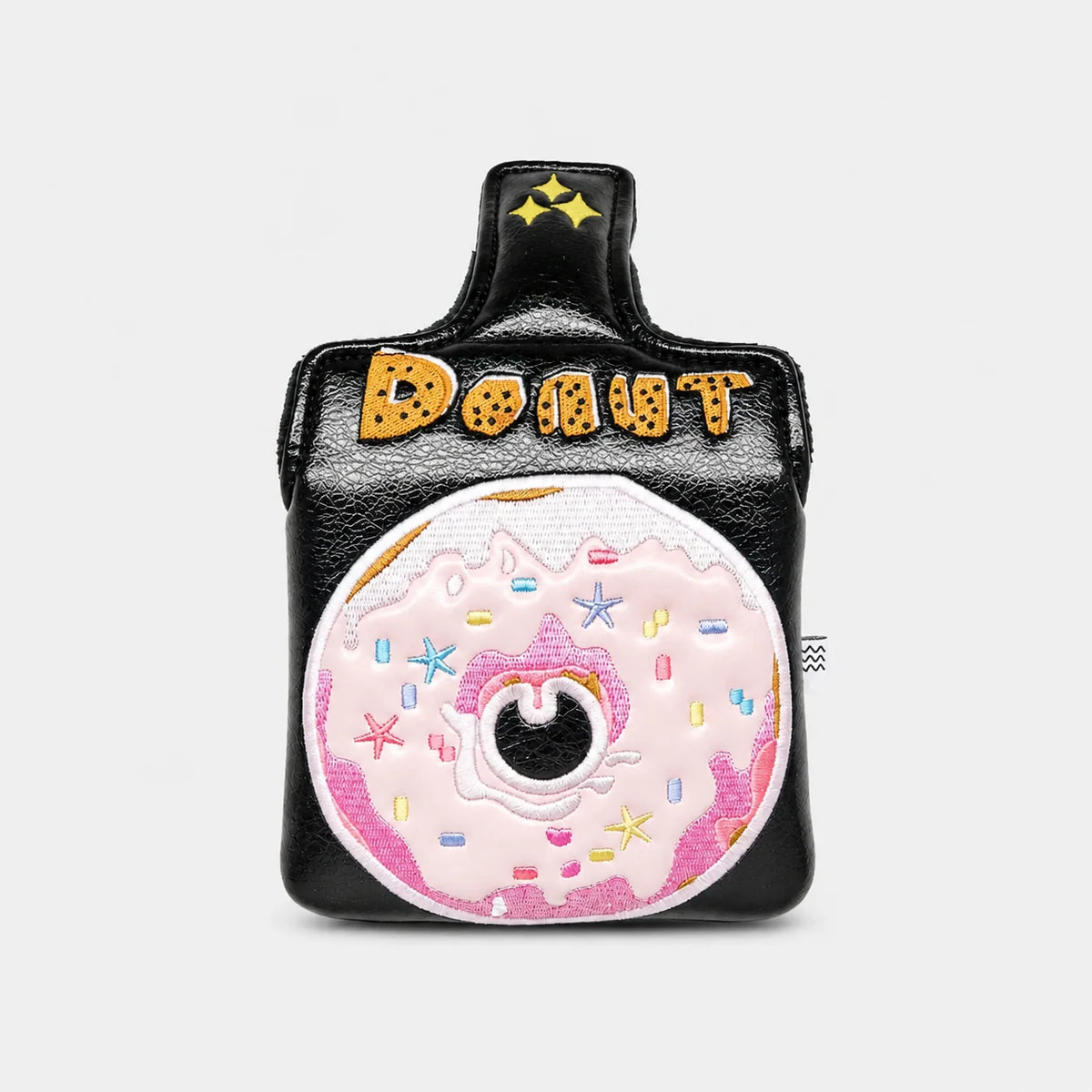 A black faux-leather mallet putter cover designed like a coffee cup, featuring a large pink donut with sprinkles on the front and the word 'DONUT' in gold letters on the handle.