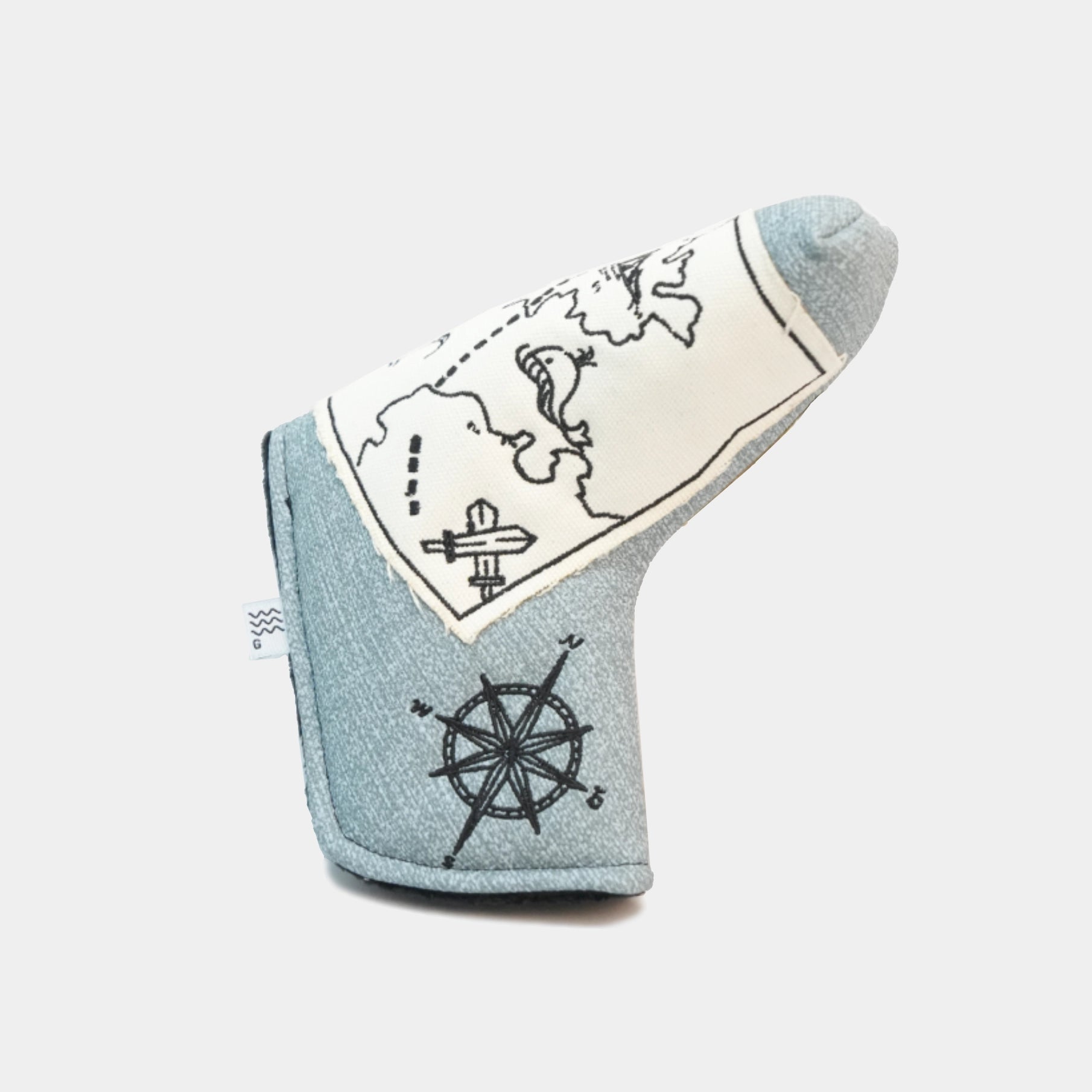 A light blue denim golf club headcover with a cream-colored map print, featuring black line drawings of a compass rose and a ship's wheel.