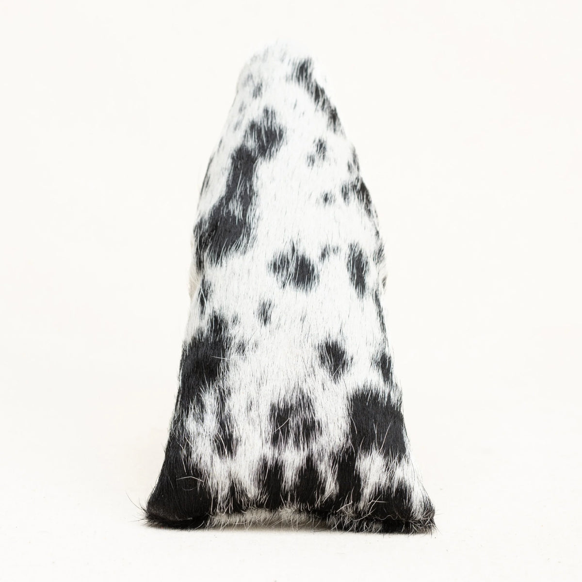 A putter cover with a black and white cowhide pattern, photographed against a plain white background.