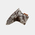 A putter cover made from mottled brown, black, and white animal fur, with a small brown leather tag attached on the right side, shown against a plain light gray background.