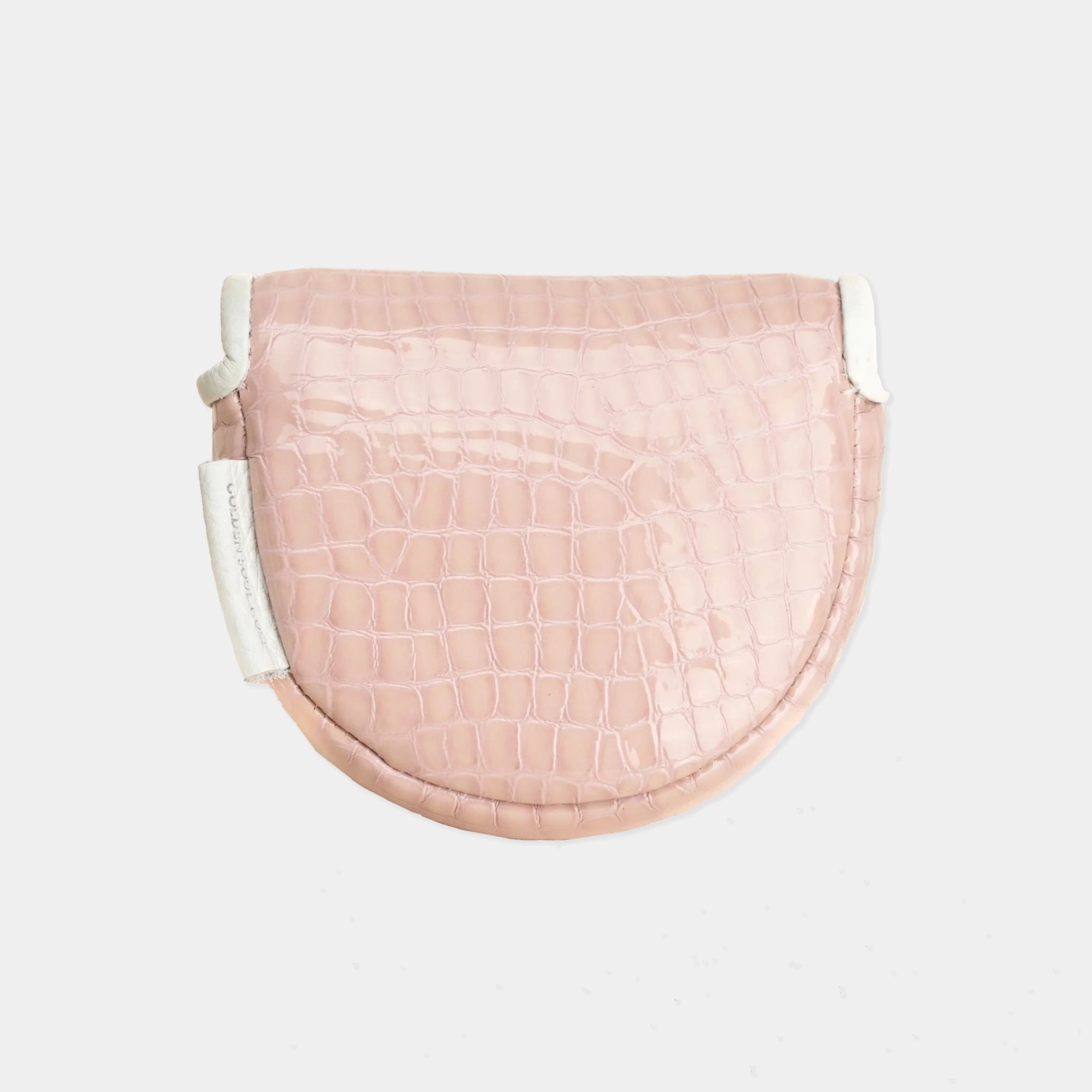 A light pink crocodile-embossed leather OZ1 putter cover with white trim and a white hanging tag, shown against a plain light gray background.