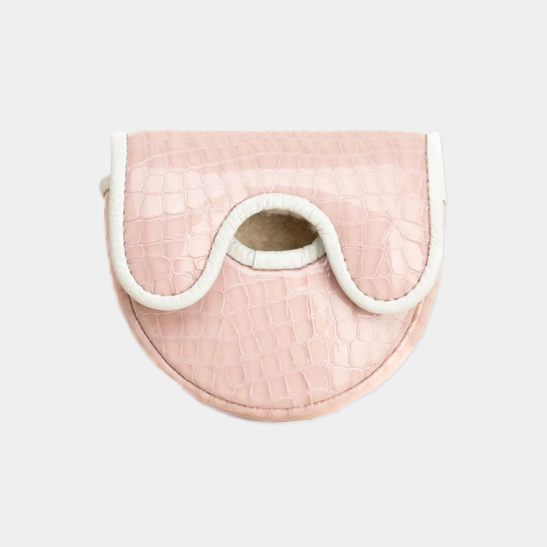 A light pink crocodile-embossed leather OZ1 putter cover with a white contrast trim and a central cutout, shown against a plain light gray background.