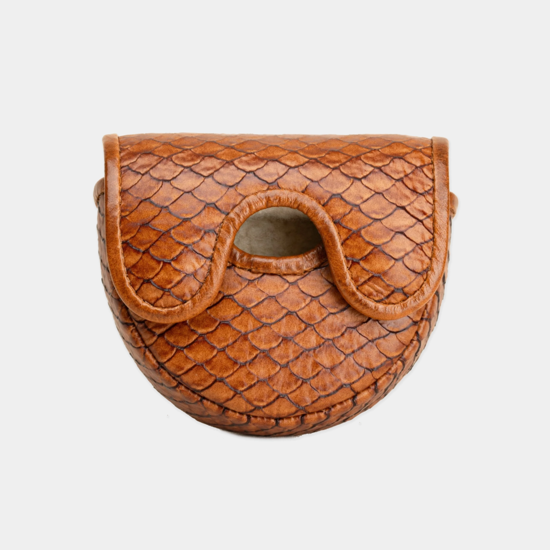 A small brown leather OZ1 putter cover with a scale-textured pattern and a curved cutout detail on the front, shown against a light gray background.