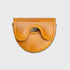 A small tan leather OZ1 putter cover with a curved flap and a central cutout, photographed on a plain light gray background.