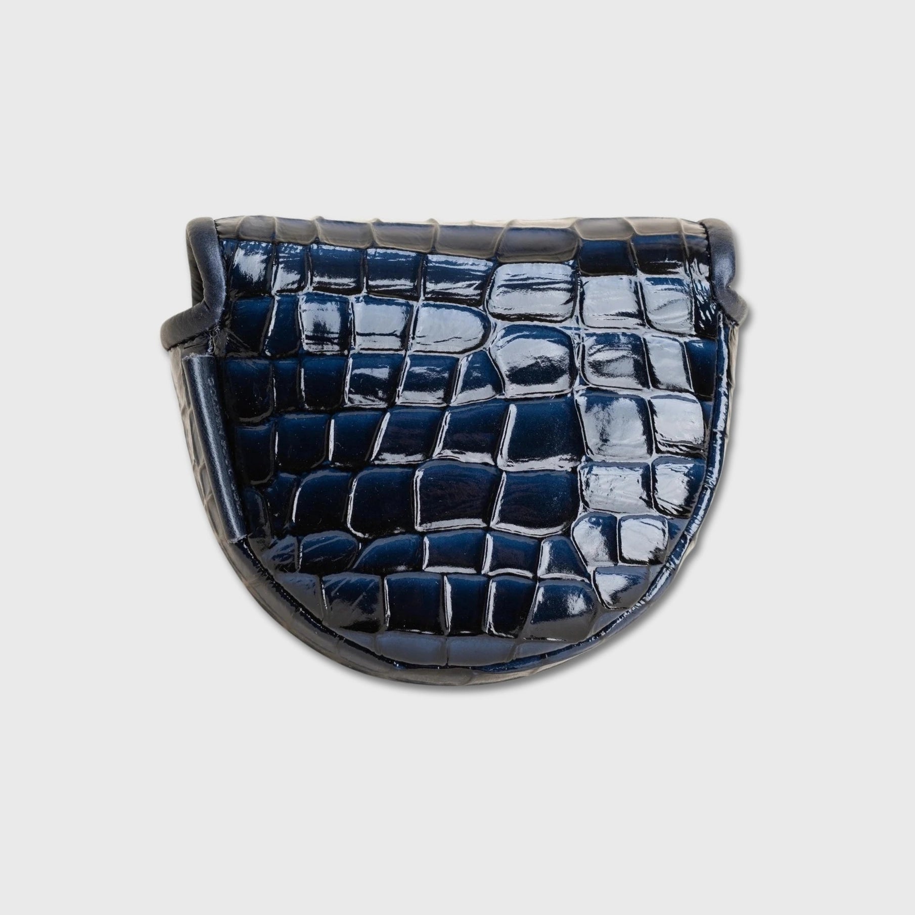 A glossy crocodile-embossed leather OZ1 putter cover in a deep navy blue, shown from a top-down view against a light gray background.