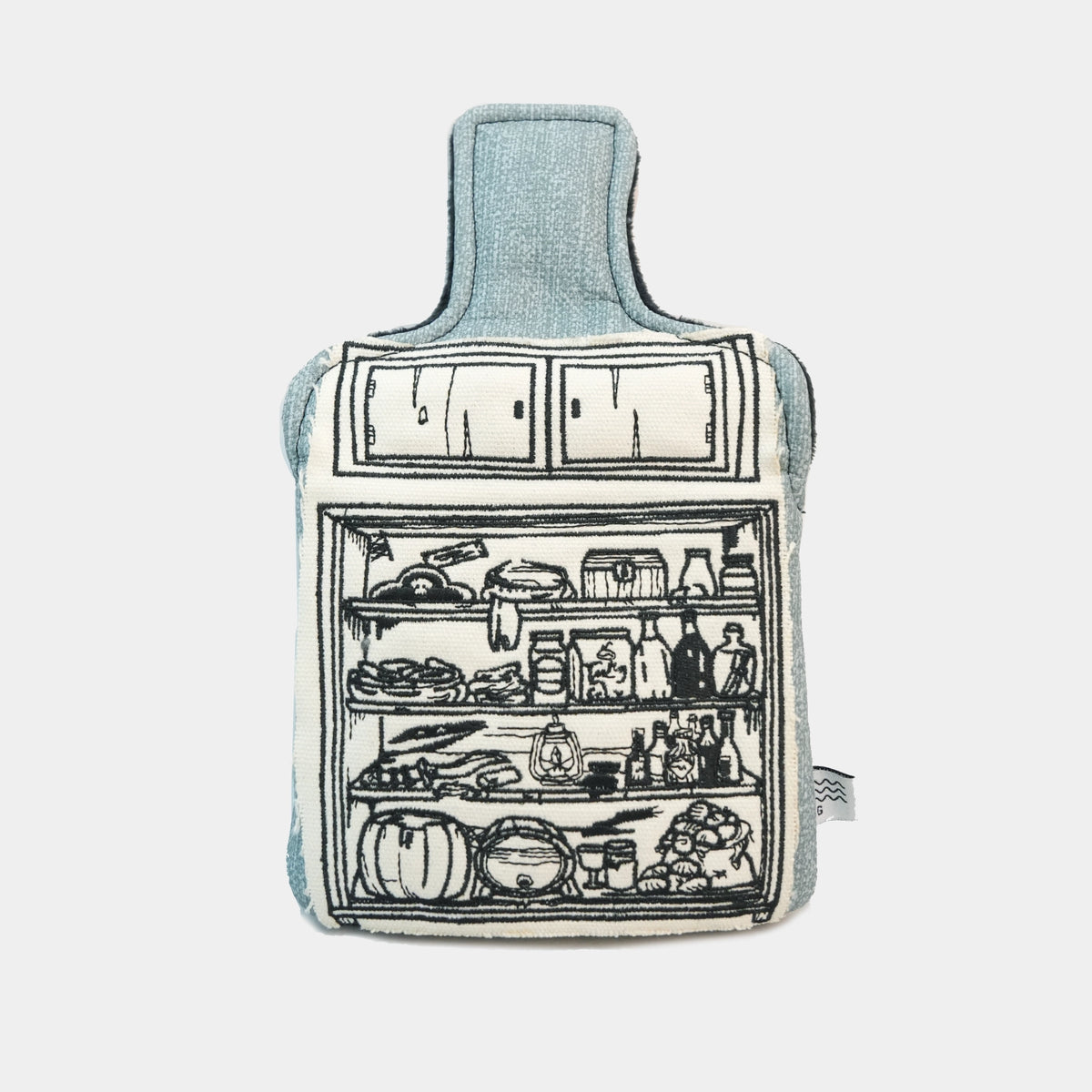 A fabric hot water bottle with a light blue denim-like body and a black line-art illustration of an open refrigerator on the front, shown against a plain light gray background.