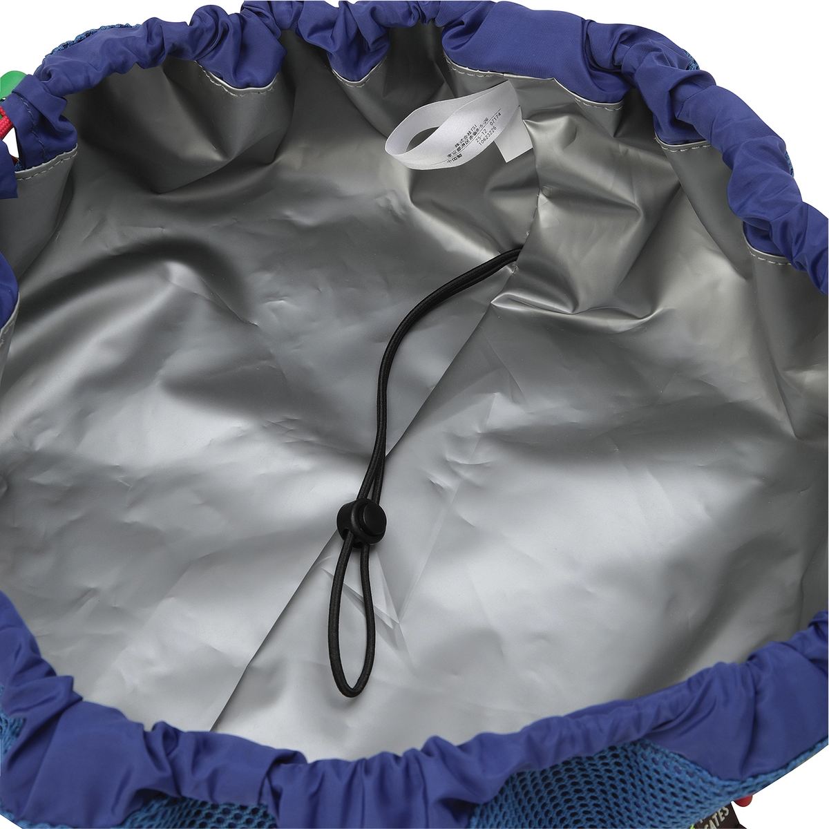 Close-up of the inside of a drawstring bag or backpack, showing a silver-gray waterproof or rainfly lining, a black drawstring cord, a white interior tag, and blue mesh and fabric trim at the opening.