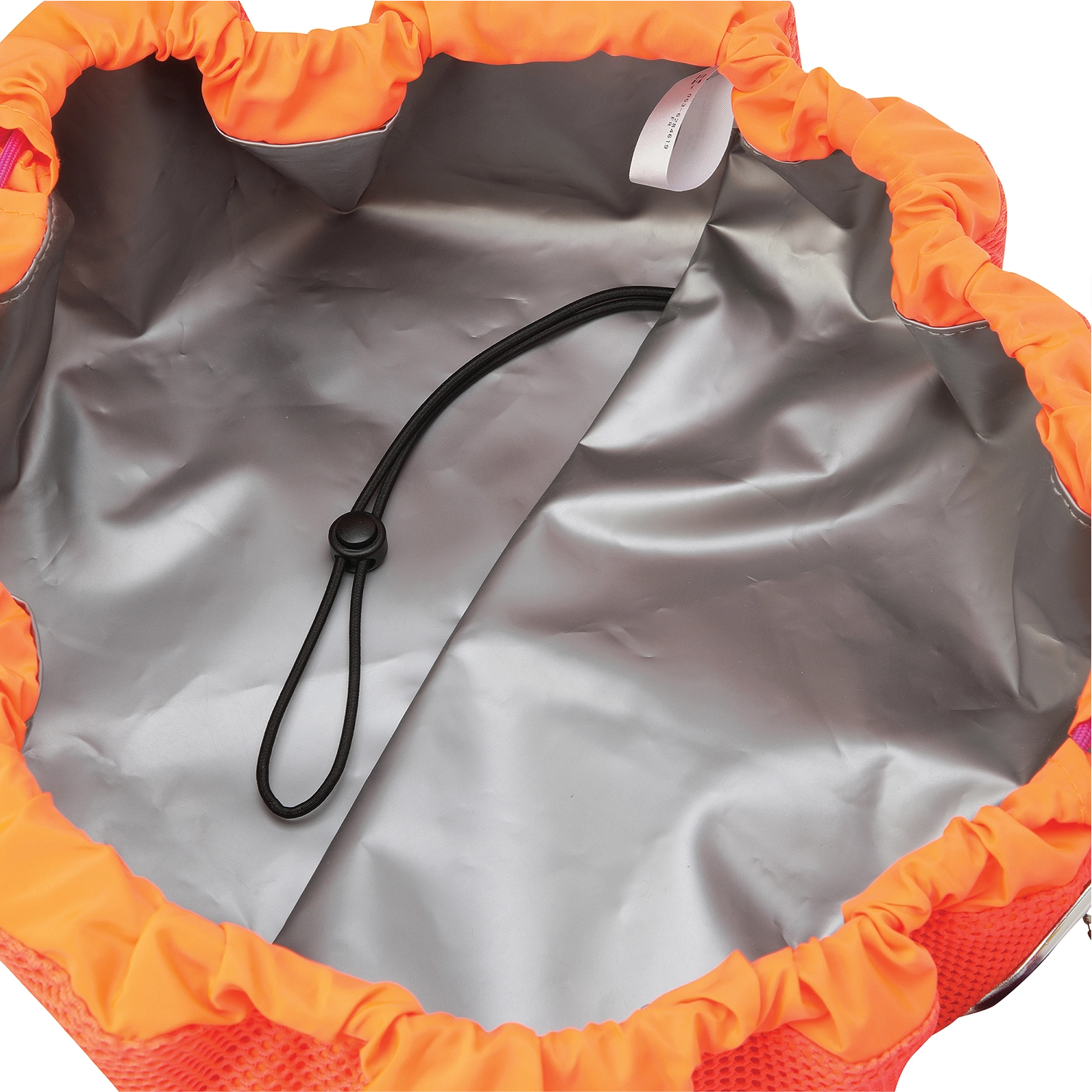 Close-up of the inside of a drawstring bag, showing a metallic silver interior lining, bright orange elasticized top, and a black drawstring cord with a toggle loop.