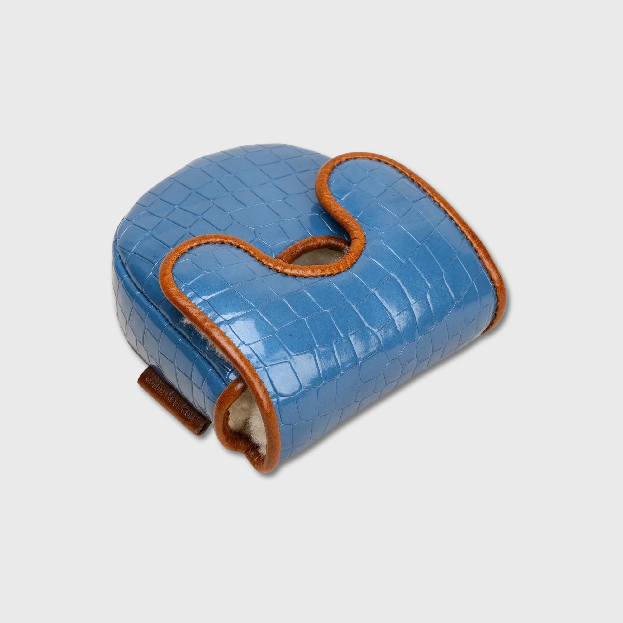 A blue crocodile-embossed leather golf club cover with tan leather trim and a white fleece lining, shown on a light gray background.