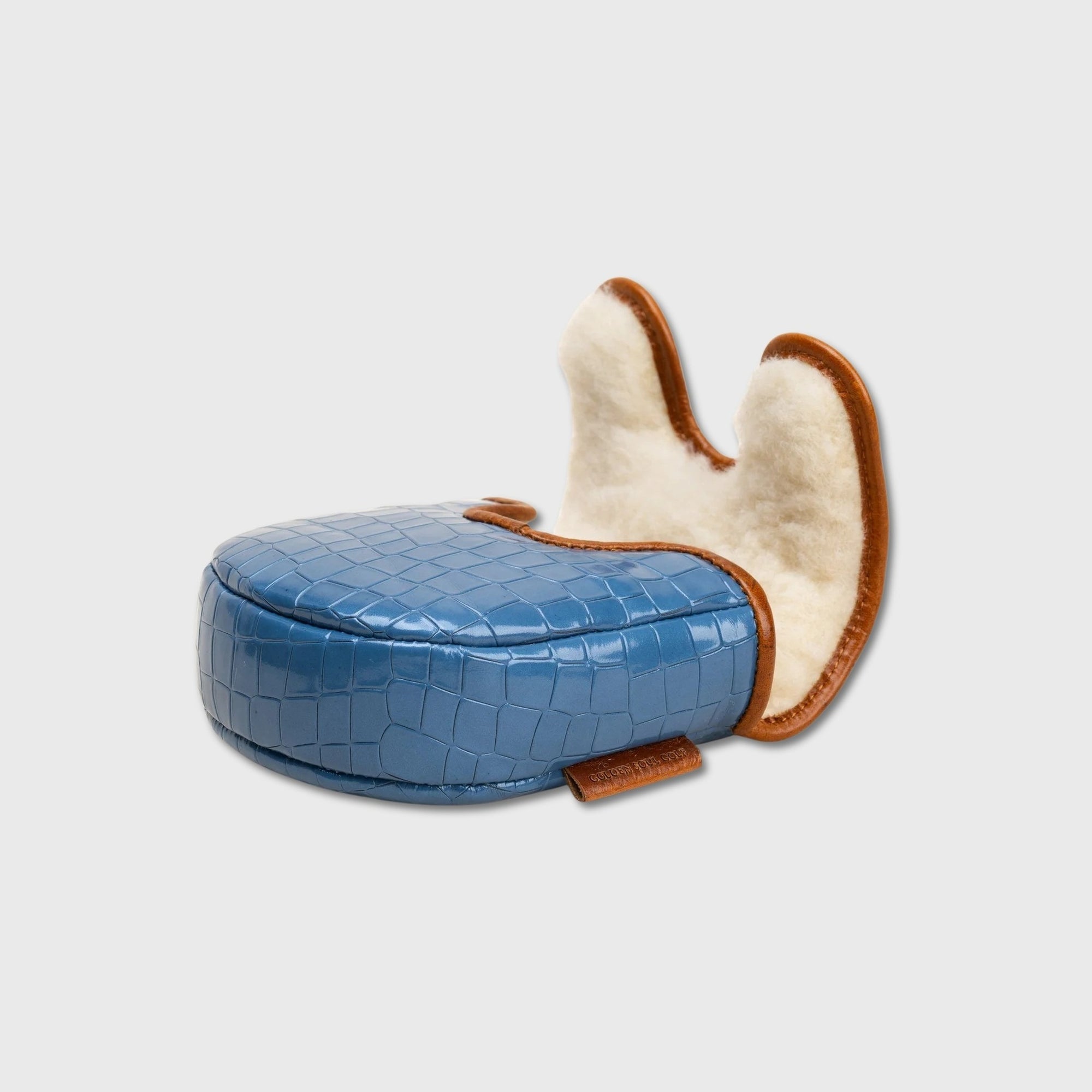 A blue crocodile-embossed leather DF3 putter cover with a cream sherpa lining and brown trim, shown on a light gray background.