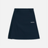 A dark navy blue pleated skirt with a small white embroidered script logo on the left side, displayed flat against a light gray background.