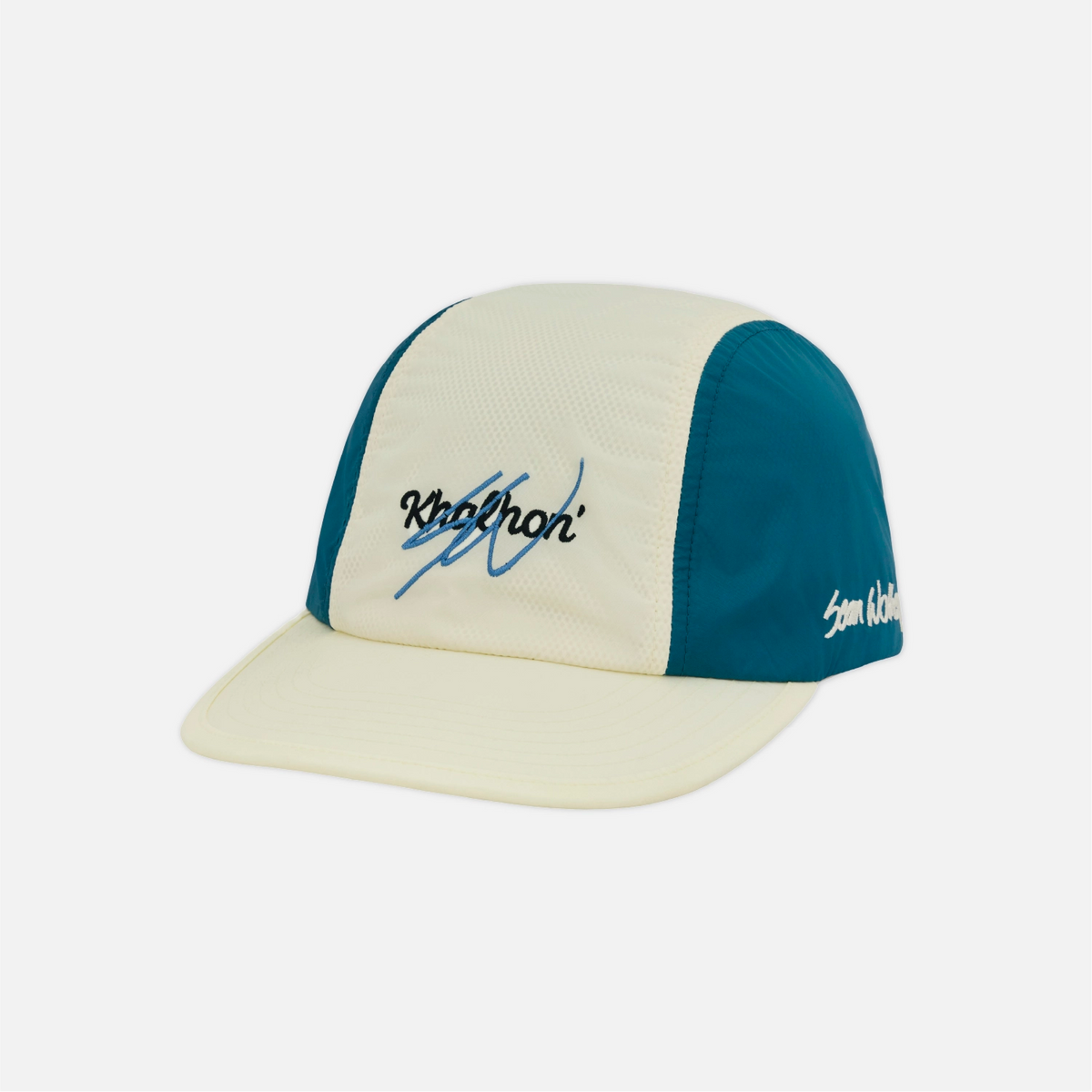 A 5-panel baseball cap with a cream-colored front panel and brim, teal blue side panels, and embroidered script logos on the front and side, shown on a light gray background.
