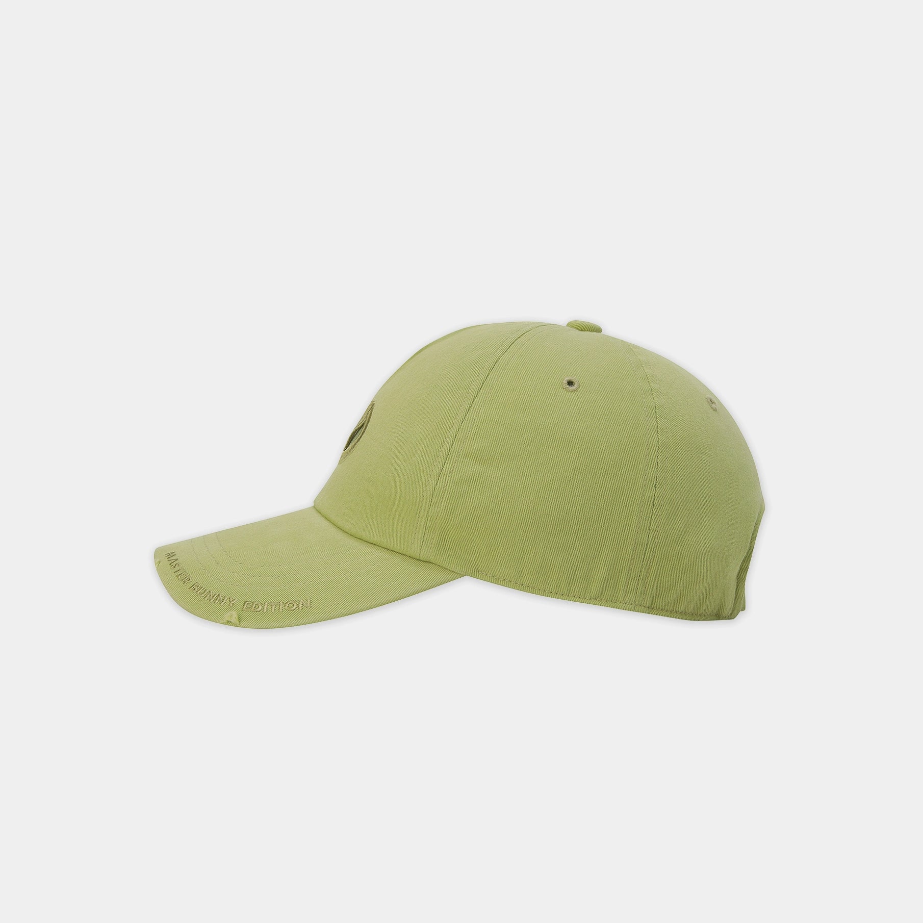 A light olive green baseball cap shown from a side profile view against a plain light gray background.