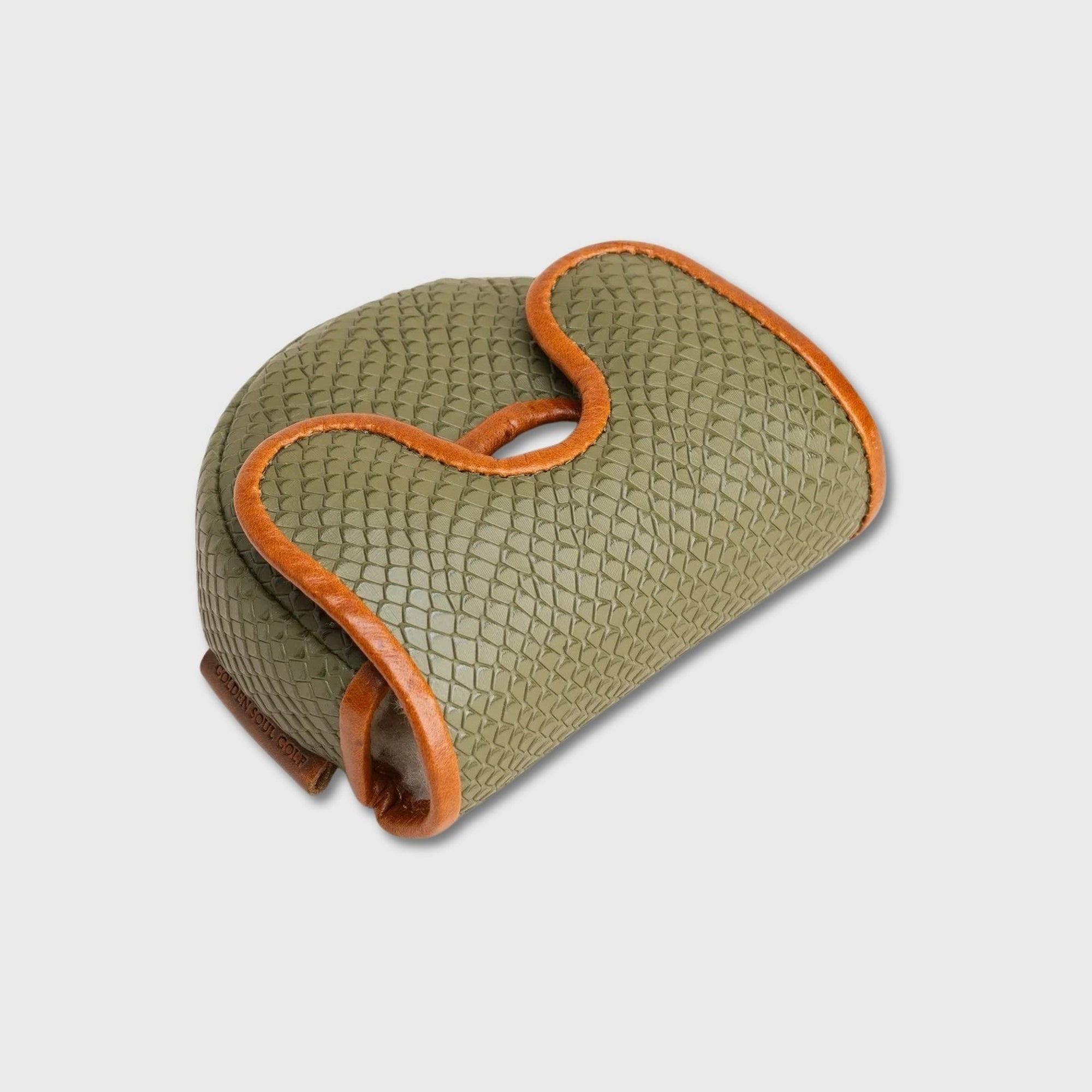 A textured olive green leather OZ1 putter cover with a distinctive S-shaped handle and contrasting tan leather trim, shown on a light gray background.