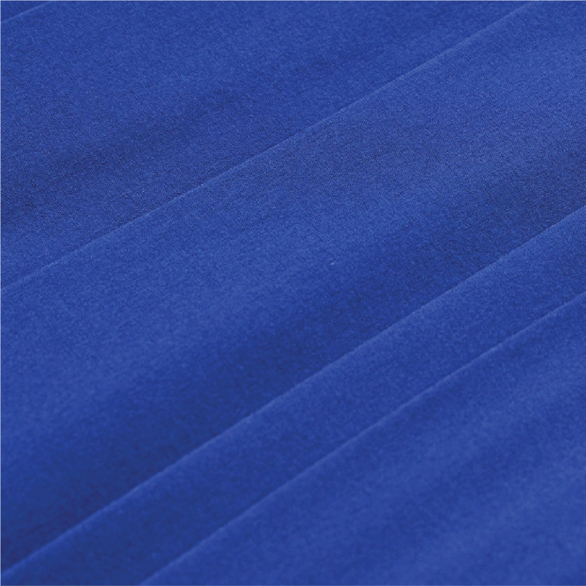 A close-up of royal blue fabric with soft diagonal folds and a smooth, slightly textured surface.