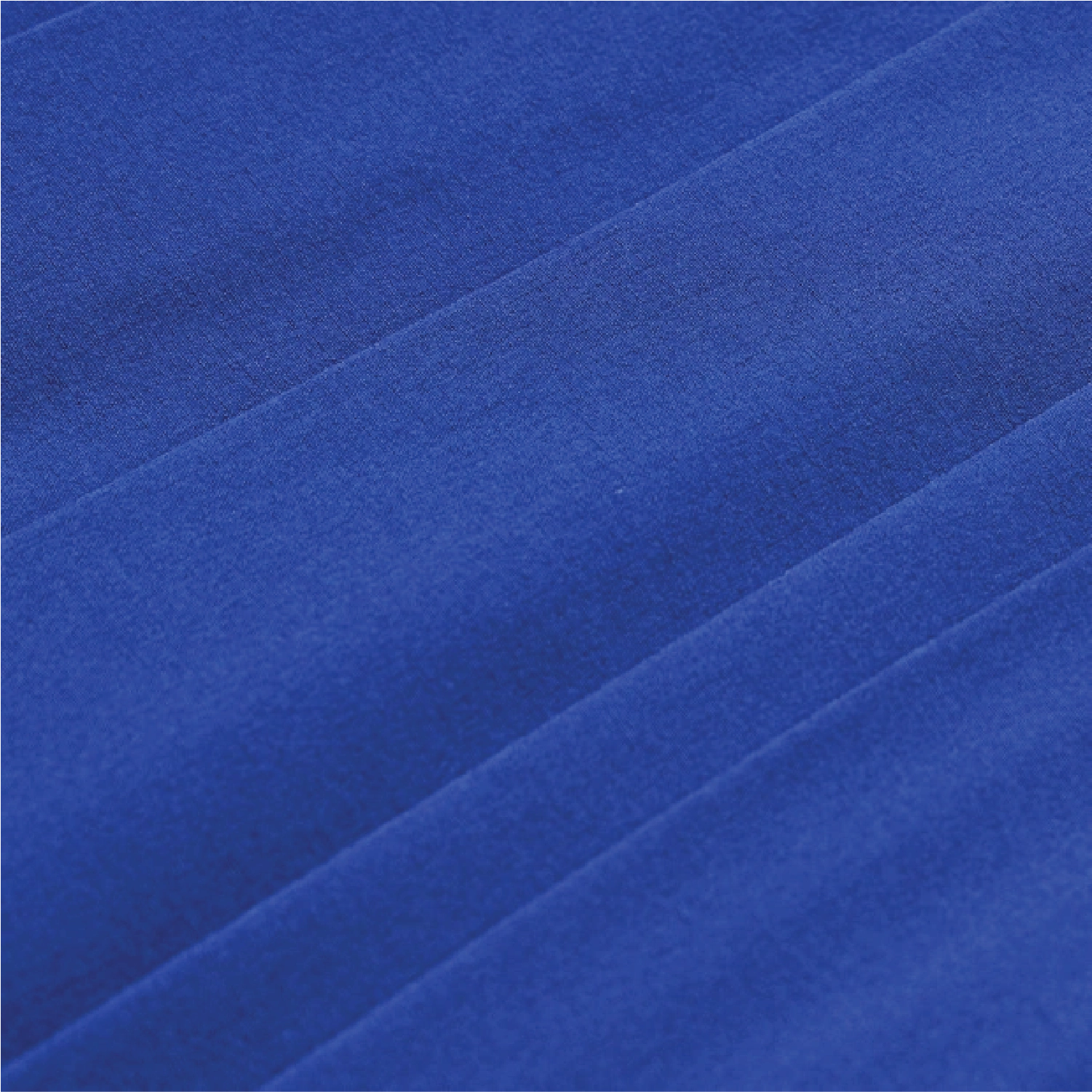 A close-up of royal blue fabric with soft diagonal folds and a smooth, slightly textured surface.