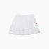 A white pleated tennis skirt with a small red embroidered logo on the side, displayed against a clean white background.