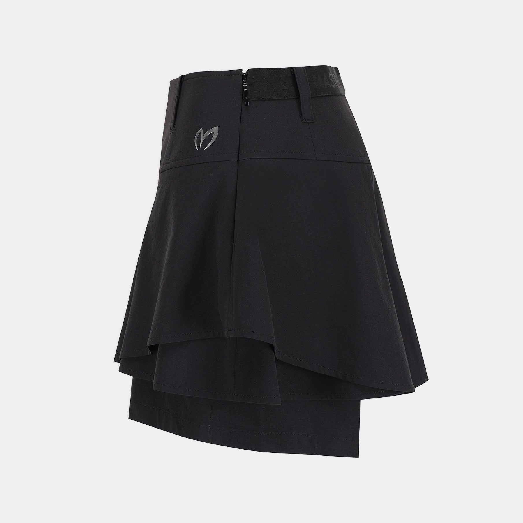 A black athletic skirt with a layered, asymmetrical ruffle design and a small gray logo on the left hip, shown against a light gray background.