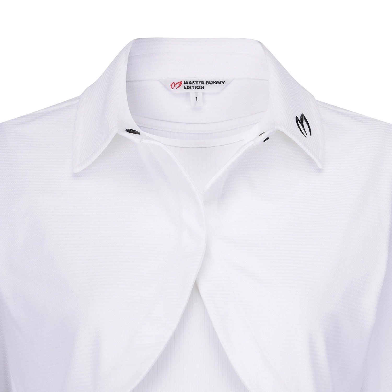 Close-up of a white collared button-up shirt with a subtle textured pattern, featuring the Master Bunny Edition logo on the inner neck label and a black embroidered logo on the collar.