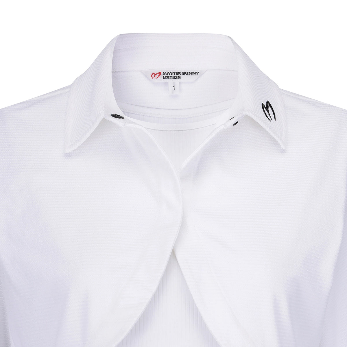 Close-up of a white collared button-up shirt with a subtle textured pattern, featuring the Master Bunny Edition logo on the inner neck label and a black embroidered logo on the collar.