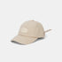 A light beige baseball cap with an oval patch on the front that reads &